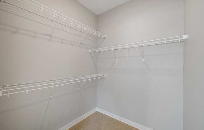 a spacious closet with shelves and hanging racks in an empty room at EagleRidge Plaza Residences, Fargo, ND