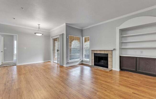 A living room with a fireplace and a sliding door.