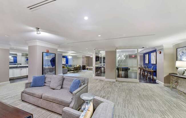 A spacious living room with a grey couch and a television.