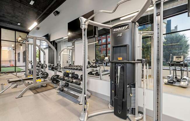 a gym with weights and cardio equipment at aria on the avenue apartments