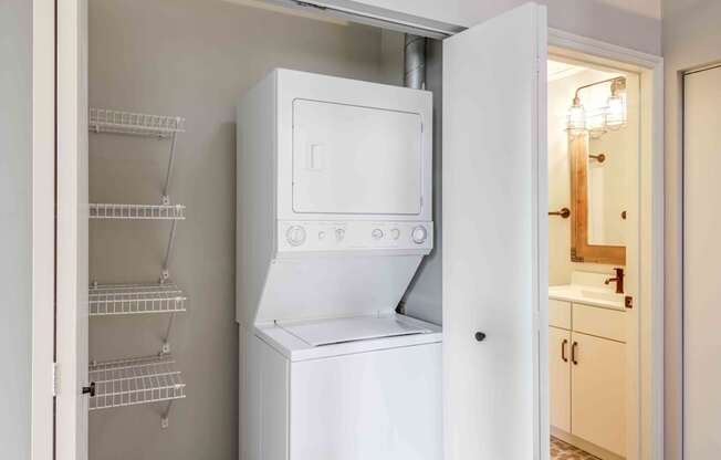 A white refrigerator with its door open in a kitchen.