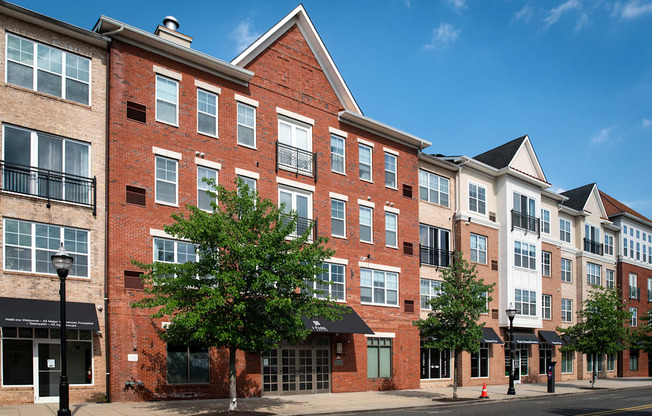 a brick apartment building on a city street at Park Square Apartments, Rahway, New Jersey