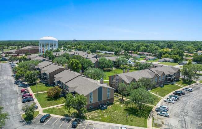 an aerial view of a neighborhood of houses with a water tower in the background