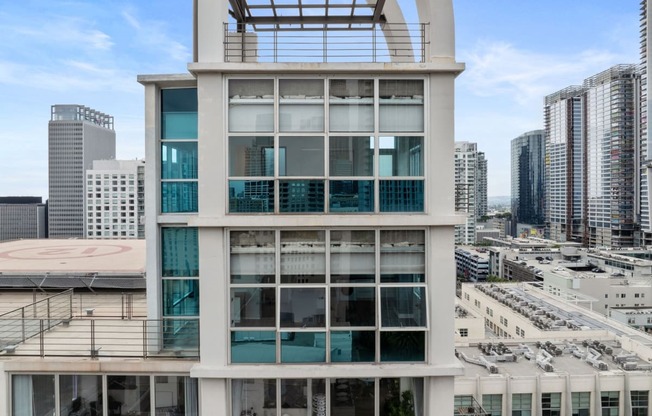 a tall white building with large glass windows and