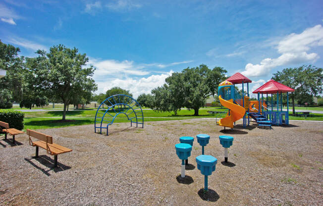 a playground with a slide and picnic table