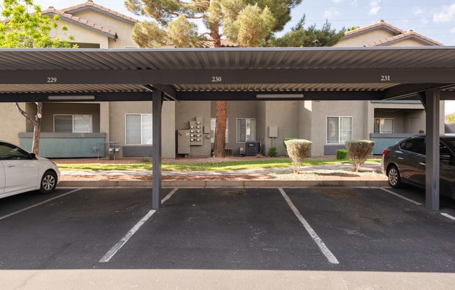 a parking lot with cars parked in front of a building