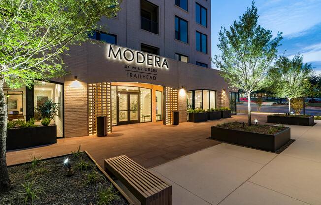 The warmly lit entrance at Modera Trailhead offers a refined welcome, setting the tone for an upscale living experience in Dallas.