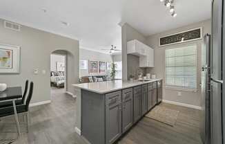 a kitchen with a large island and a dining room in the background