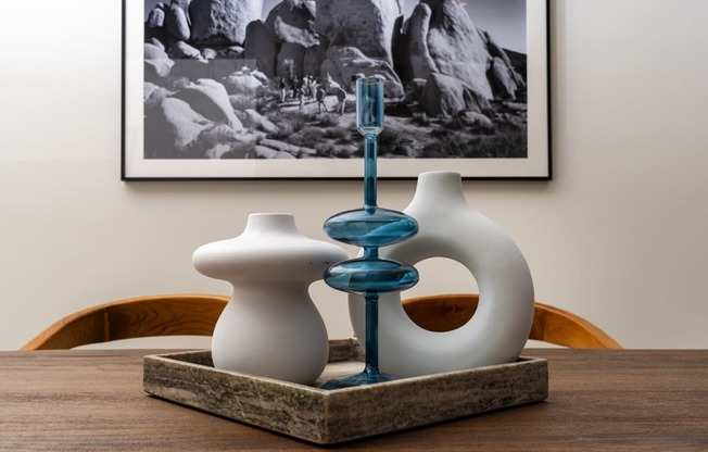 a table with two vases and a toothbrush on it