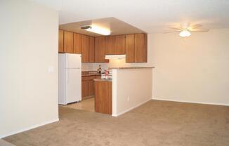 a kitchen with wooden cabinets and a refrigerator
