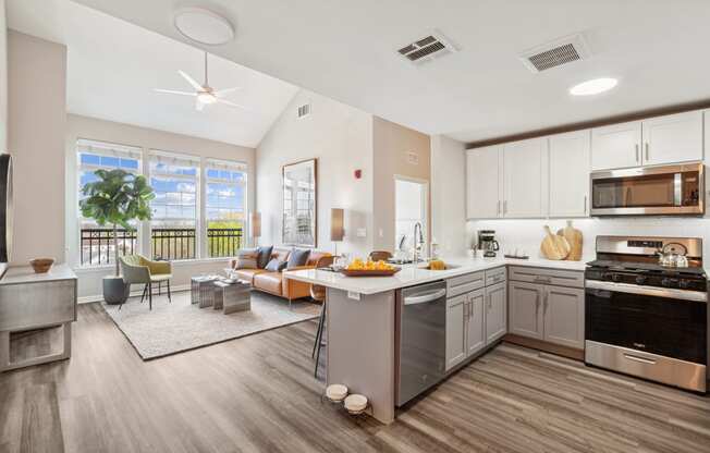 a kitchen and living room with a large window at Metro 303, Hempstead New York