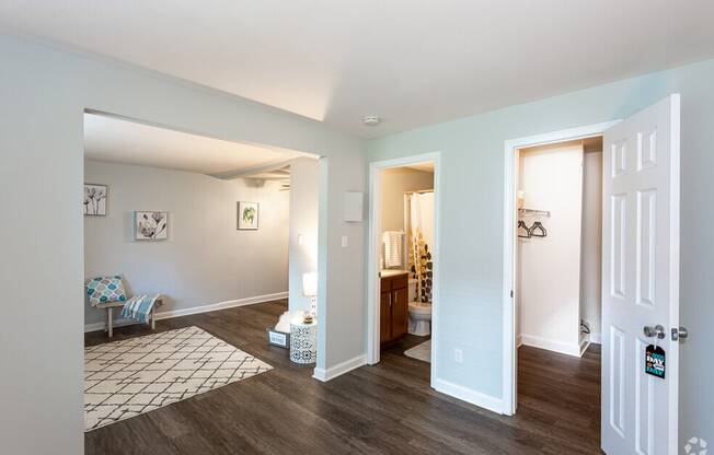 a view of a living room and a bathroom from the hallway