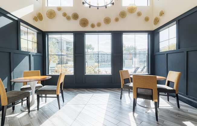 a dining room with tables and chairs and a large window