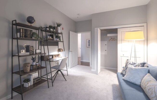 a home office with a desk and bookshelf in a living room
