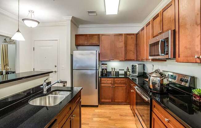 a kitchen with wooden cabinets and a stainless steel refrigerator