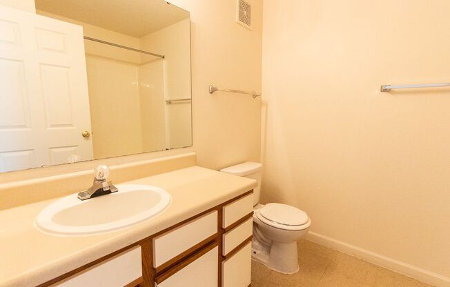 Bathroom with a sink toilet and mirror at Maple Tree Apartments in LaPorte, IN