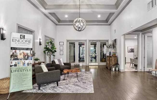 A leasing office with chairs and a rug at Encore at Buckingham Apartments in Richardson, TX