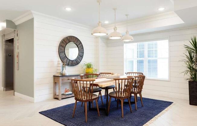 Wood dining table in light and airy lobby