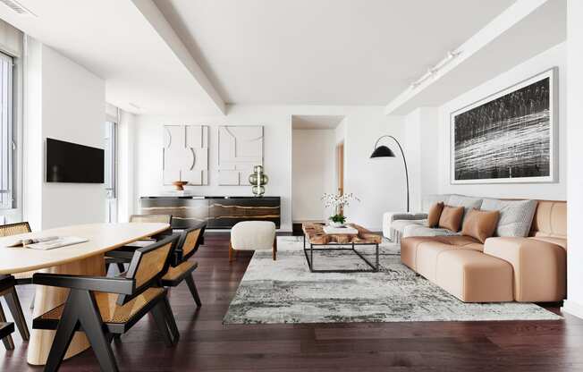 a living room with white walls and hardwood floors
