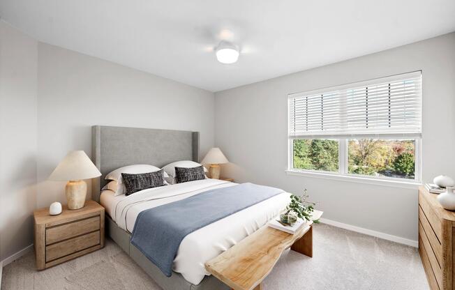 Bedroom with expansive windows, soft carpeting, and a bright, airy atmosphere,