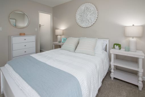 Model apartment spare bedroom with a bed and two night stands