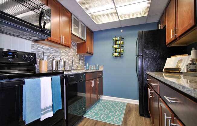 a kitchen with black appliances and a black refrigerator