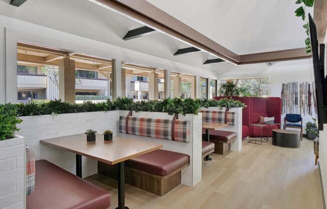 a lobby with red chairs and potted plants at Summerwood Apartments, Santa Clara, CA 95050