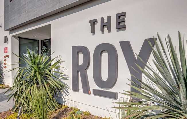 A large sign on a building that says "THE ROY".