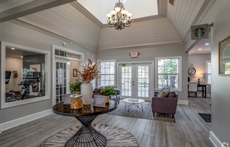 the view of a living room with a table and chairs