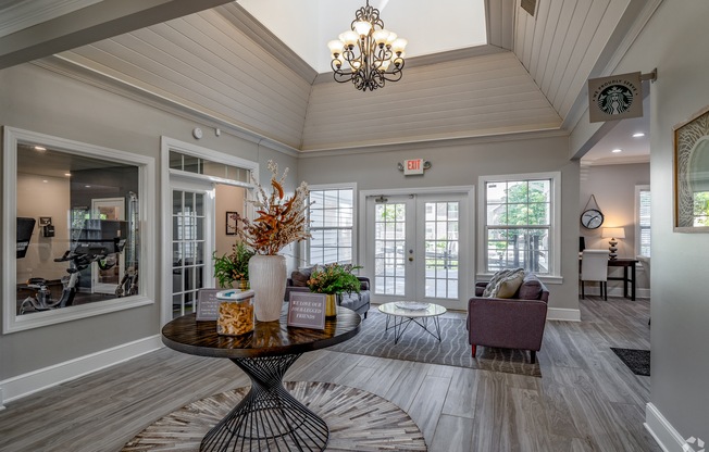 the view of a living room with a table and chairs