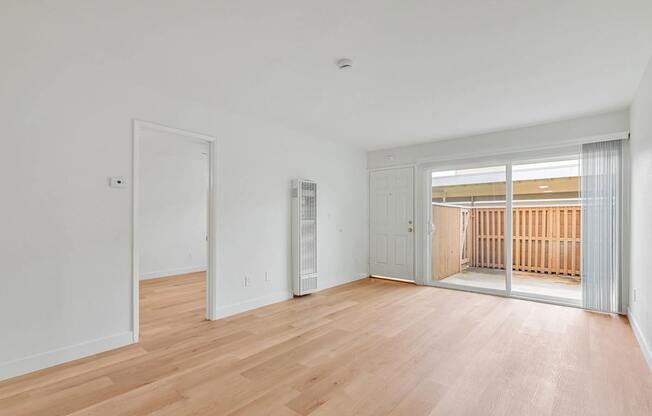 A room with wooden floors and white walls.