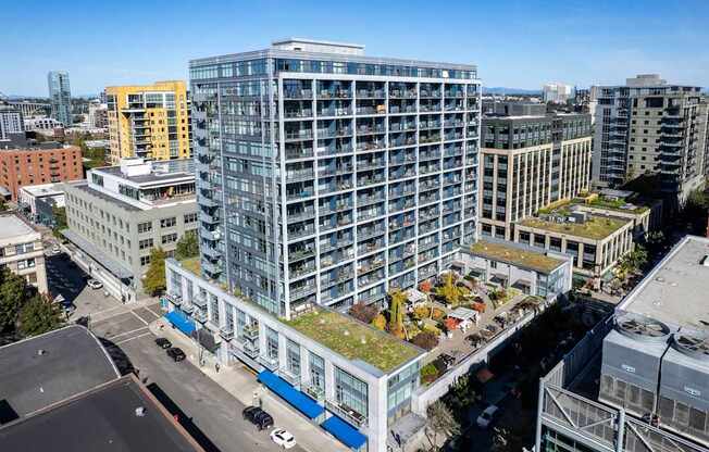 an aerial view of a tall building with a green roof