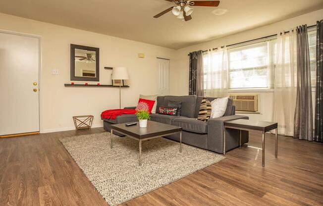 a living room filled with furniture and a large window