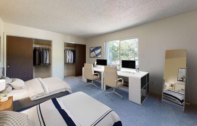 a bedroom with two beds and a desk with a computer