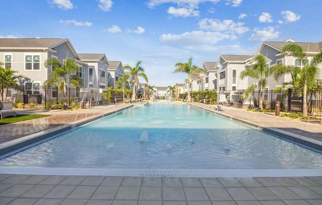 a large swimming pool with houses in the background  at Palm Grove, Florida