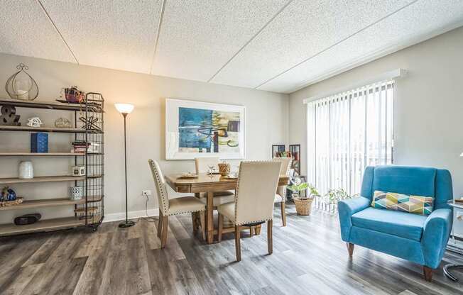 A dining room with a wooden table and chairs.