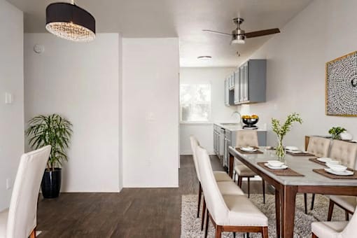 A modern dining room with a wooden table and chairs.