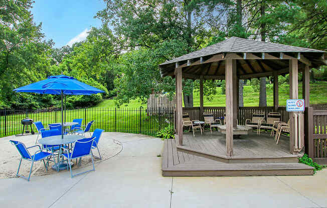 a patio with a gazebo and tables and chairs