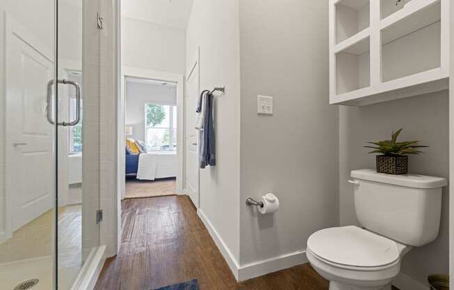a bathroom with a toilet and a glass shower