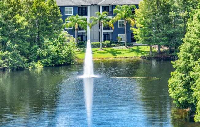 a fountain in a pond at Verano apartments