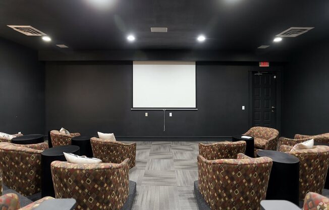 a large room with chairs and a projector screen