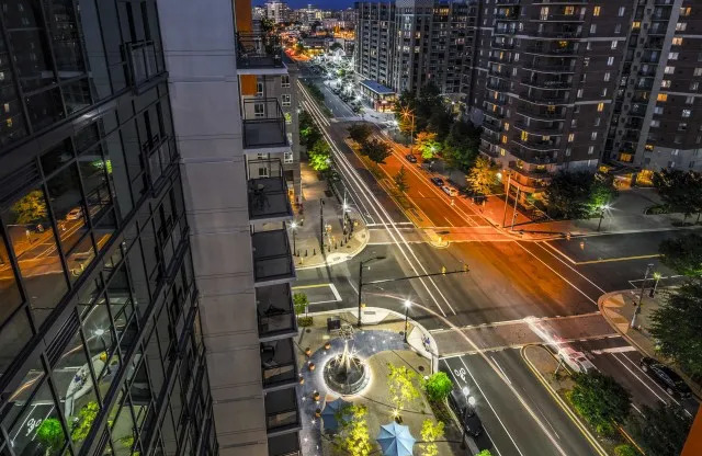The streets of Arlington as seen from the Latitude Apartments, featuring a view of cars passing at night.