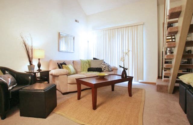 furnished living room with large sliding door providing lots of natural light at Skyline View Apartments