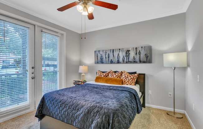 a bedroom with a bed and a ceiling fan