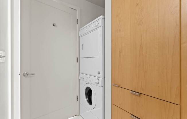 A white dishwasher and washing machine in a small room.