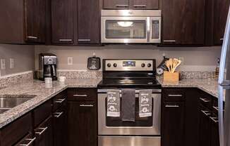 a kitchen with stainless steel appliances and granite counter tops