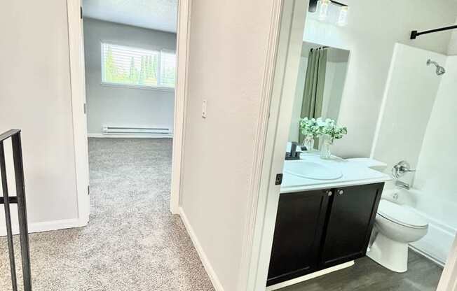 Campbell Plaza Apartments
710 Nido Drive, Campbell, CA 95008. A bathroom with a toilet, sink, and mirror.