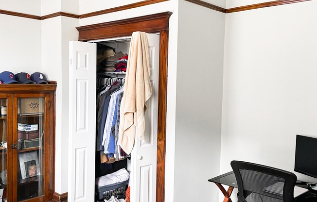 a room with a closet and a desk and a chair in it