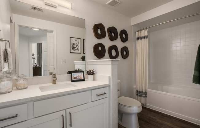 a bathroom with a large mirror and a toilet and a shower