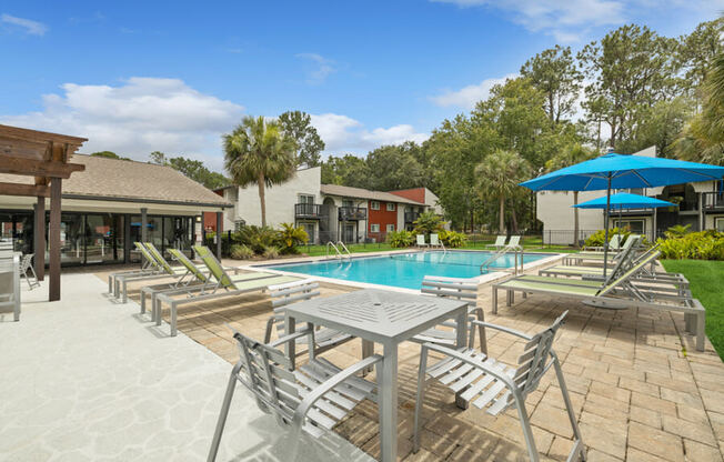 Sundeck with tables and a swimming pool